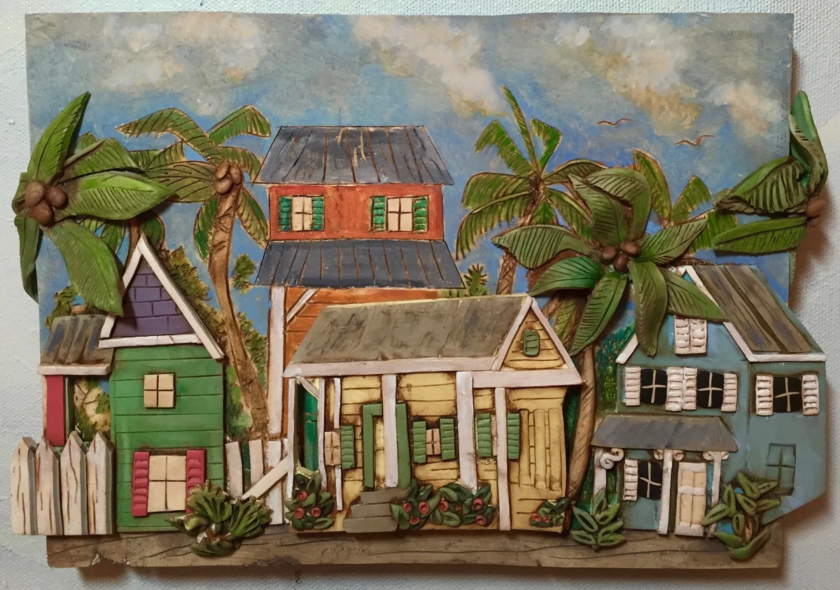 Dimensional polymer clay painting of a row of Key West conch houses in green, blue and red with coconut palms against a cloudy sky