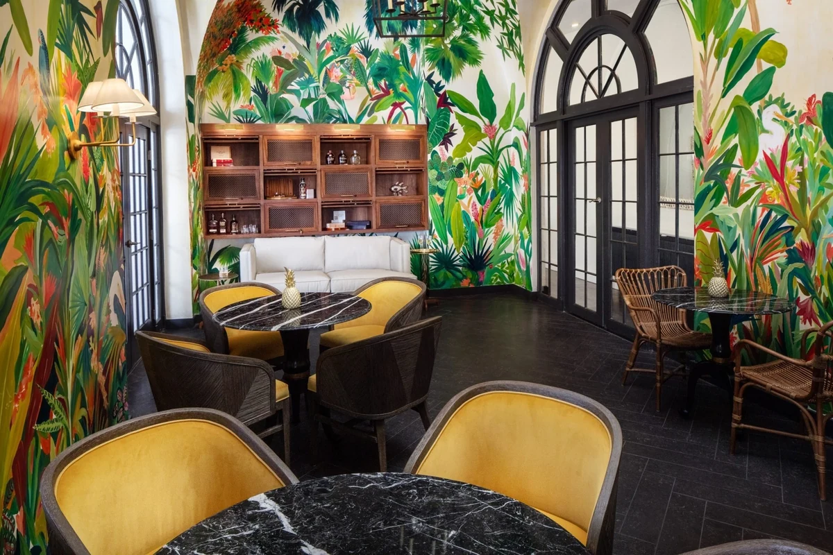 The Canary Room, her full-room jungle mural at the Casa Marina Resort, Key West, wrapping the walls of an empty cafe room