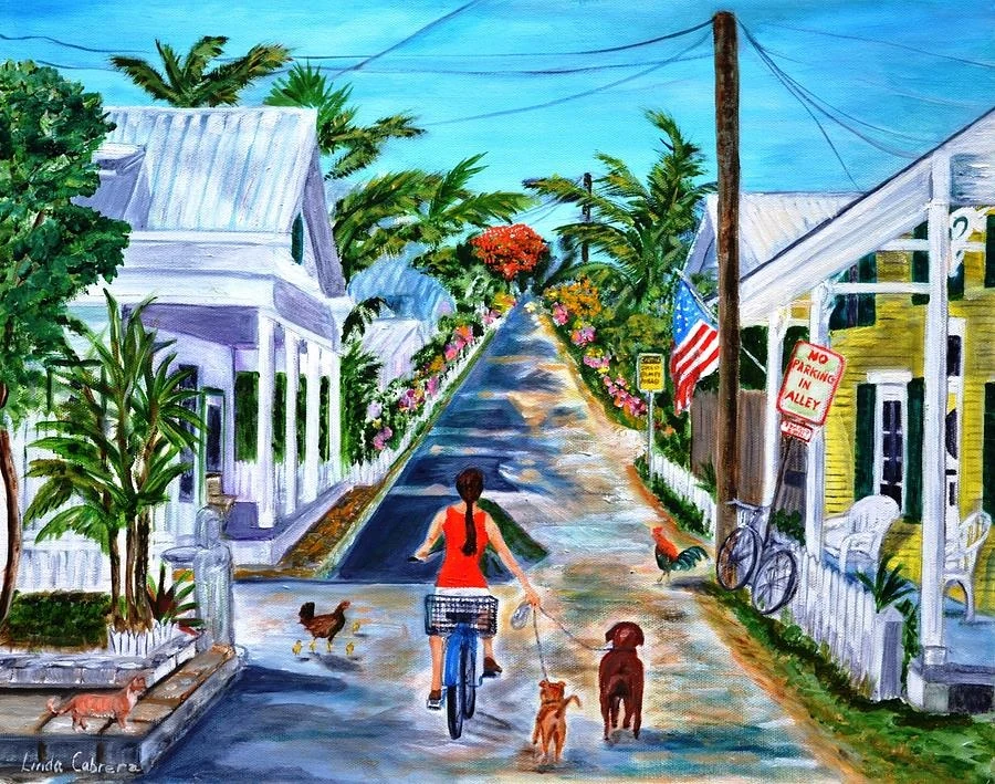 Key West Lane: a woman in a red dress bicycling down a lane between conch houses, walking two dogs, with roosters, a royal poinciana in bloom and a flag on the porch