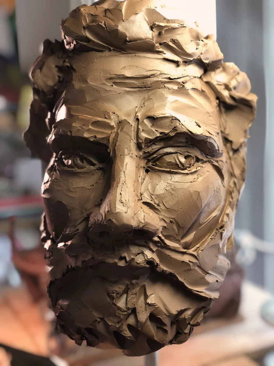 Head of a Saint, 2018, clay, a bearded head modelled in loose knife-cut planes