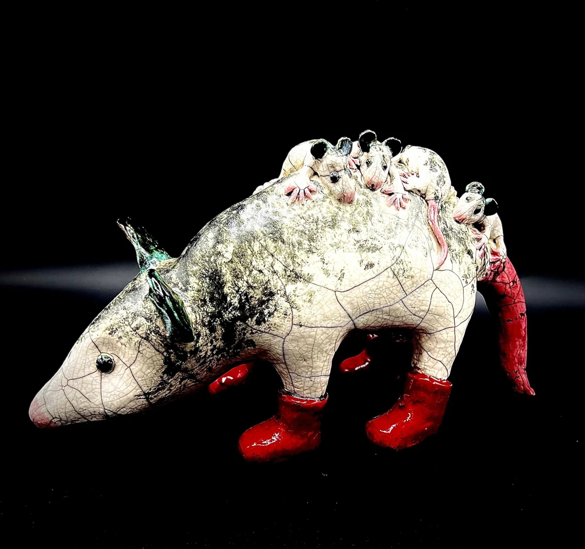 "Safety First", Raku ceramic sculpture of a possum carrying her babies on her back and wearing red boots