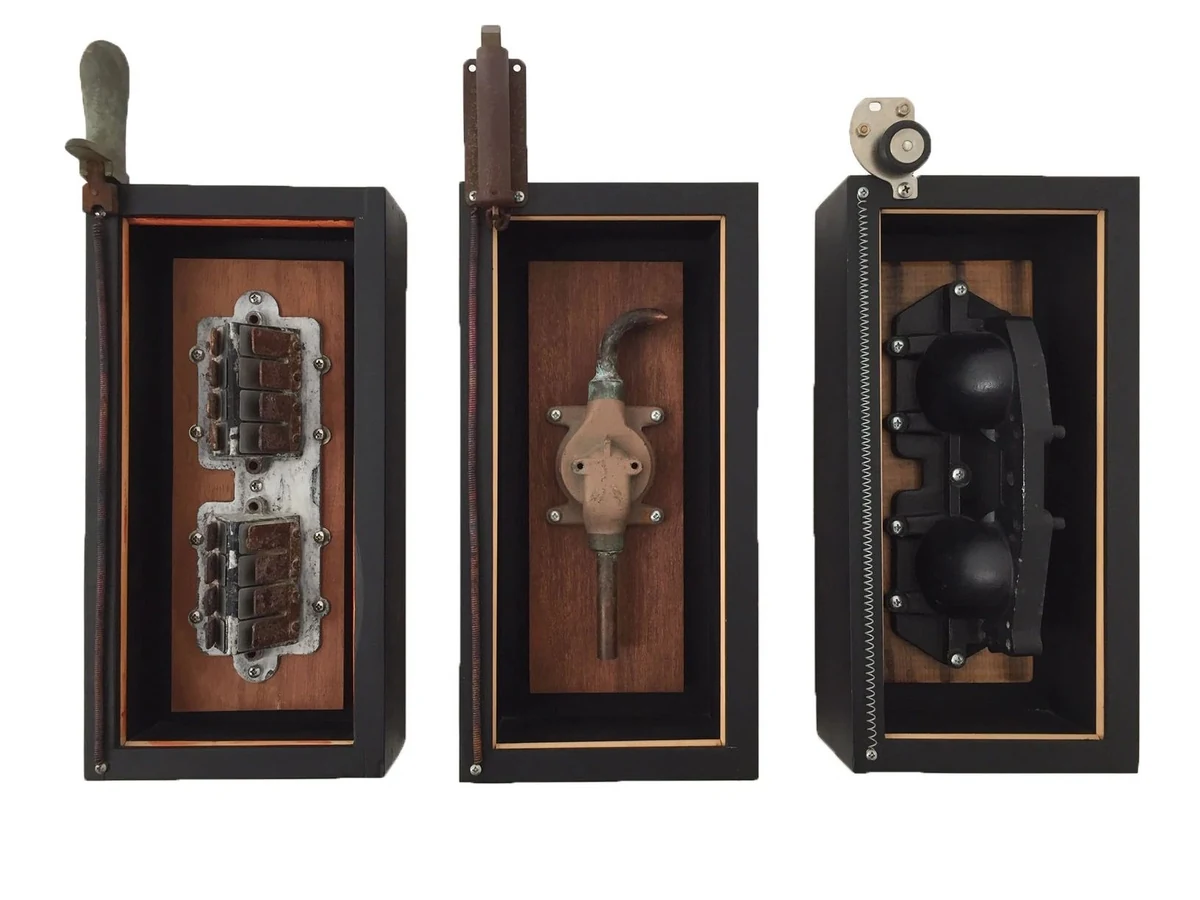 Obsolete I, II, III, triptych of three black shadow boxes each holding an obsolete machine part on wood, 7 x 17 x 3.5 inches each